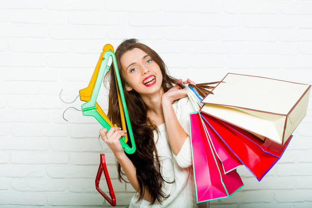 woman with shopping bags and hangers - Foto, imagen