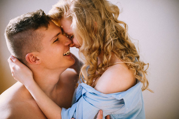 Young beautiful loving couple hugging and kissing, tender relationships - Fotó, kép