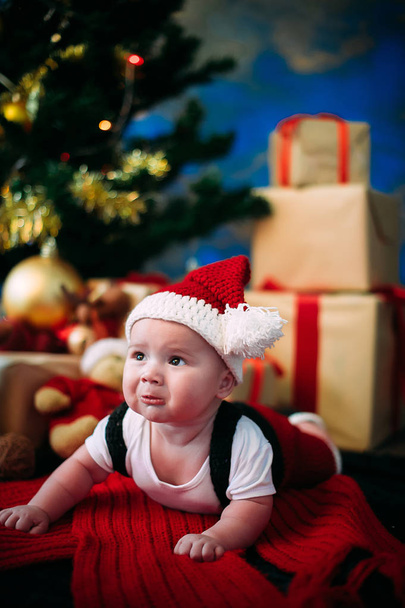 New Year's Concept. Adorable little boy near a Christmas tree with presents.  new year - Photo, Image