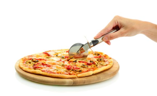 woman's hand with a knife cut the pizza on white background close-up - Photo, Image