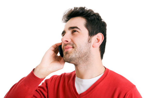 Young casual man talking on the phone isolated on white background - Fotografie, Obrázek