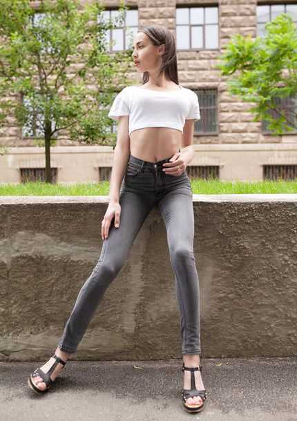 Beautiful brunette young woman wearing black jeans - Fotoğraf, Görsel