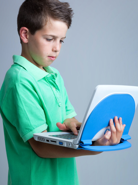 Boy with laptop on grey background - Фото, изображение