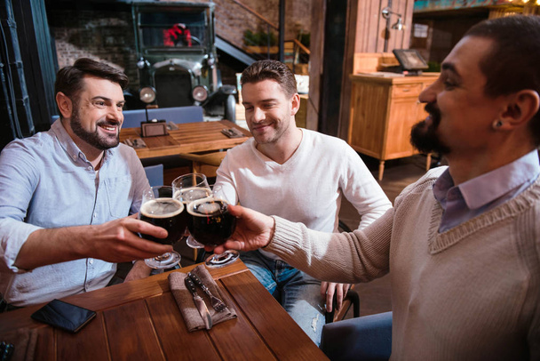 Happy cheerful men drinking alcohol - Фото, изображение