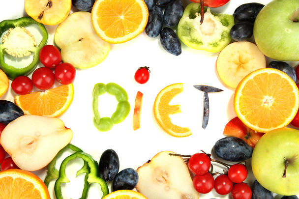 The word Diet lined with pieces of fruits and vegetables isolated on white - Foto, immagini