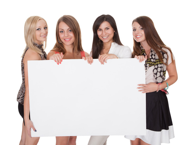 Four attractive women with blank sign - 写真・画像