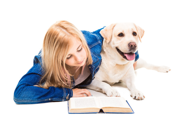 girl reading a book with Labrador retriever on isolated white - Φωτογραφία, εικόνα