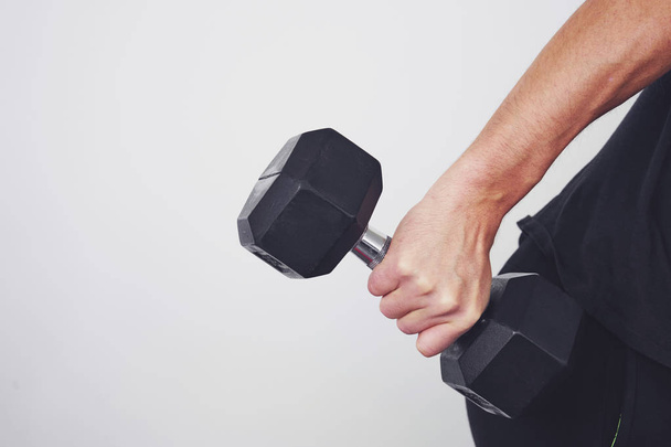 Fit muscular man exercising with dumbbell - Fotó, kép