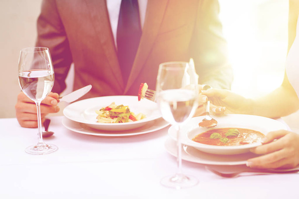 close up of couple eating appetizers at restaurant - Photo, image