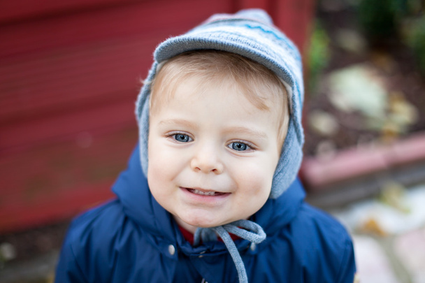 Cute toddler in warm autumn clothes - Photo, Image