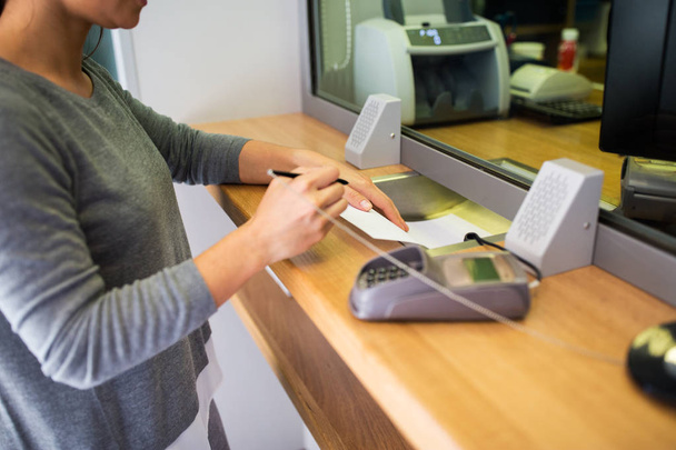 customer writing application at bank office - Foto, Bild