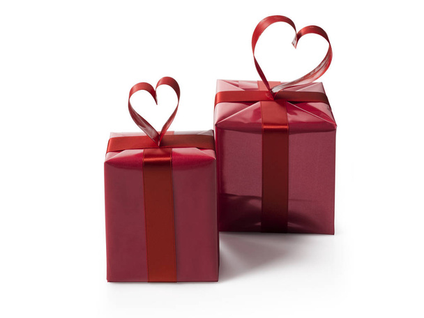 two red gift boxes with red hart shaped ribbon bow - Zdjęcie, obraz