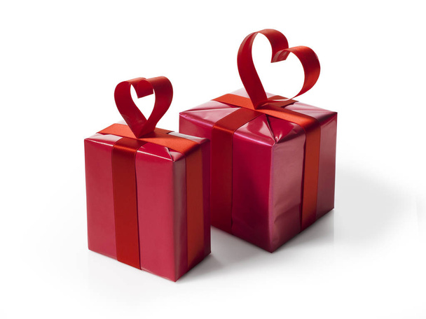 Red gift box with red hart shaped ribbon bow - Zdjęcie, obraz