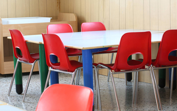 sillas rojas con bancos pequeños de un preescolar
 - Foto, imagen
