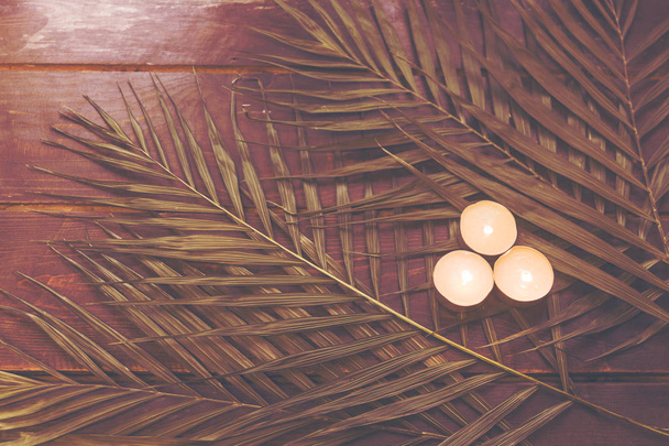 Palm leaves on a wooden surface - Fotografie, Obrázek