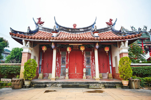 Traditional oriental temple with beautiful decoration in Taiwan (Chinese Translation on lantern:Jen-wen Academy, on board:improve the society by education) - Zdjęcie, obraz