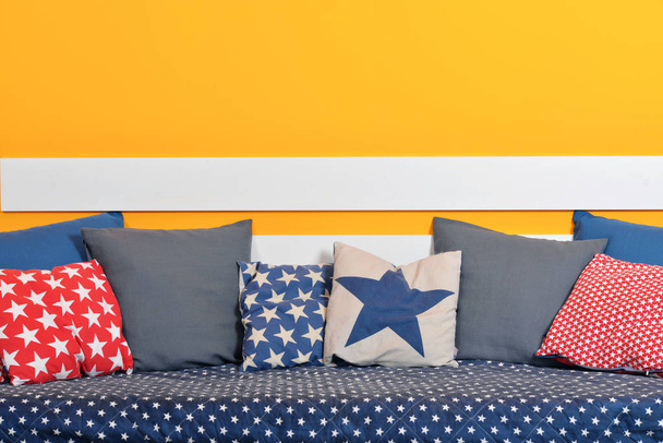 Children's bed with different color pillows  - Fotografie, Obrázek