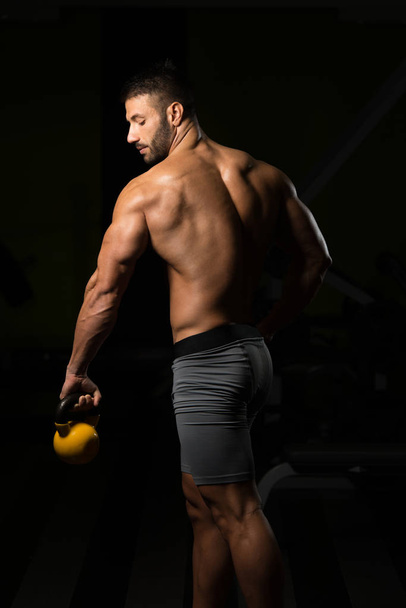 Portrait Of A Physically Fit Man With Kettle-bell - Foto, immagini