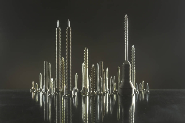     City skyline made of bolts and screws  - Foto, Imagen