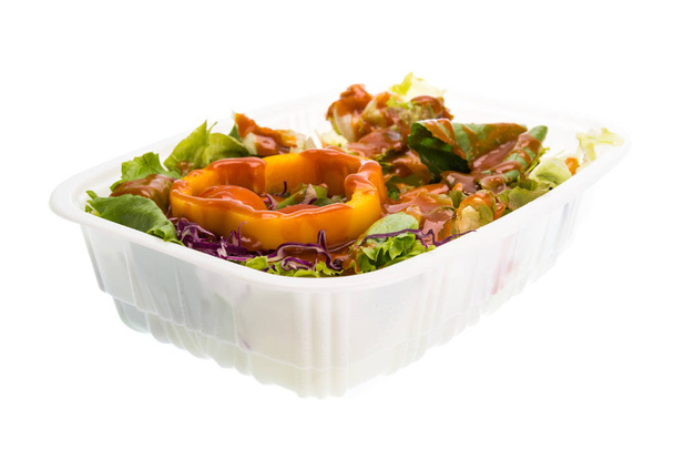 mix salad with tomato dressing in plastic container isolated  - Photo, image