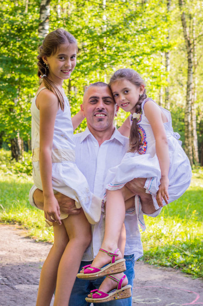 Daddy hugs his daughters - Photo, image
