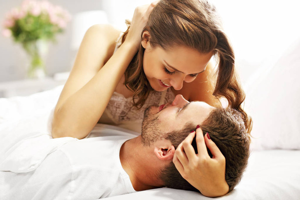 Young couple hugging in bed - Photo, image