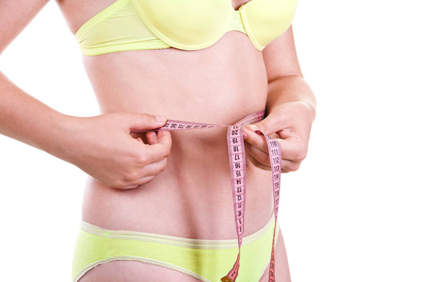 Girl measuring her waist volume - Photo, Image