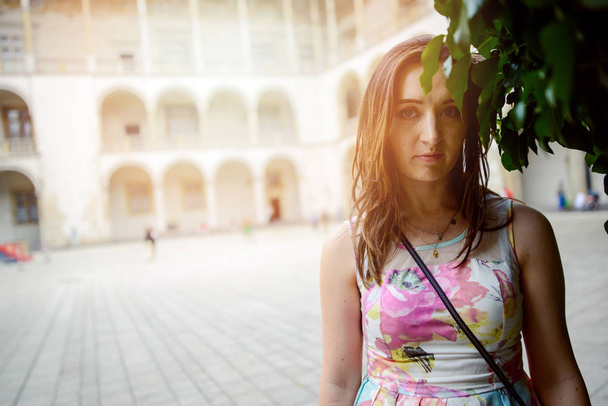 Beautiful girl during sightseeing old castle in Cracow, Wawel. - Photo, Image