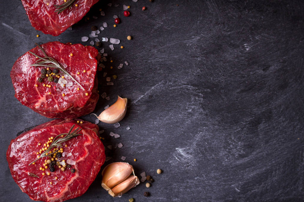 Raw filet mignon steaks with spices - 写真・画像