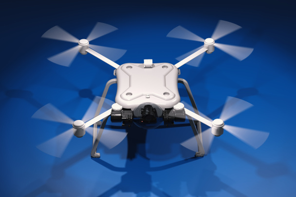 белый дрон с вращающимися винтами
 - Фото, изображение