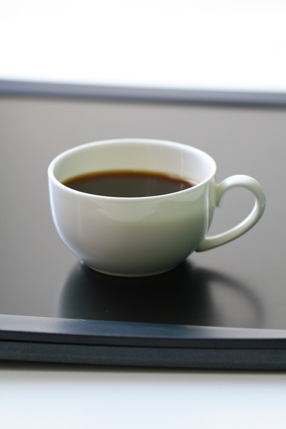 kopje van koffie en touch screen display - Foto, afbeelding