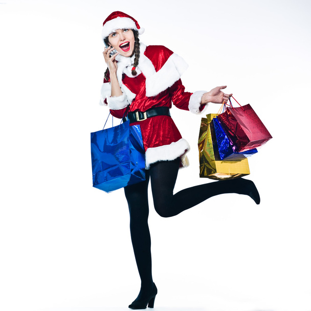 woman santa claus Christmas Shopping on the phone - Foto, Imagem
