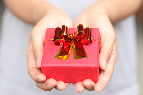 Red Gift box on women hands. - Photo, Image