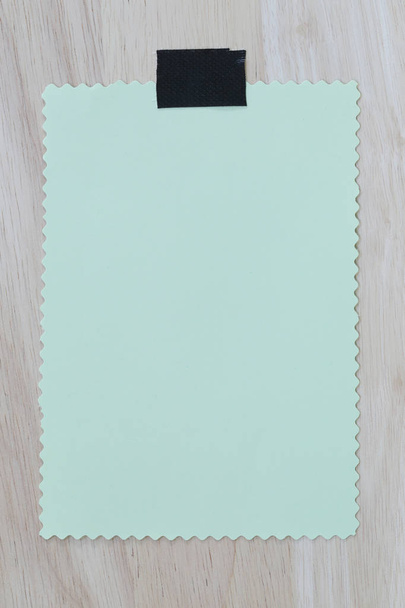 grünes Notizblock-Papier aus Leer- und Kopierraum auf Holzgrund - Foto, Bild