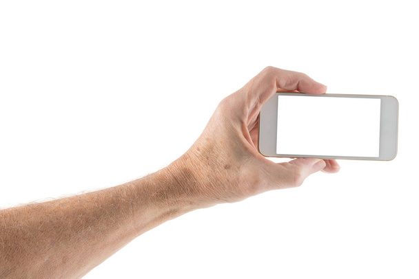 Чоловіча ліва рука тримає смартфон з порожнім екраном
 - Фото, зображення