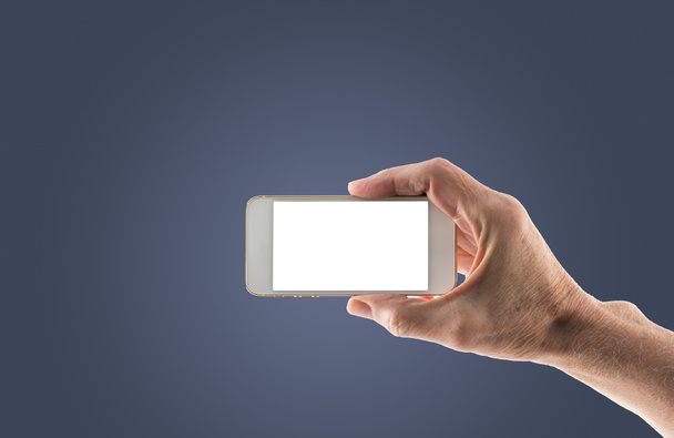 Mano derecha masculina sosteniendo smartphone con pantalla en blanco
 - Foto, Imagen