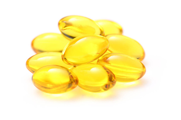 Golden color oil supplements in soft gel capsule - Photo, Image