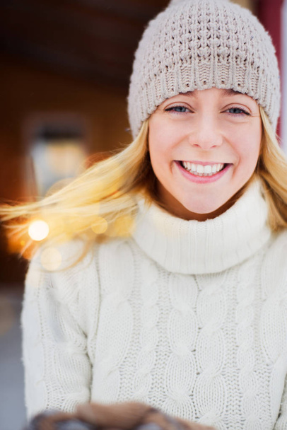 Pretty girl in hooked hat holding sparkler in her hand and smiling outdoor - Foto, Imagen