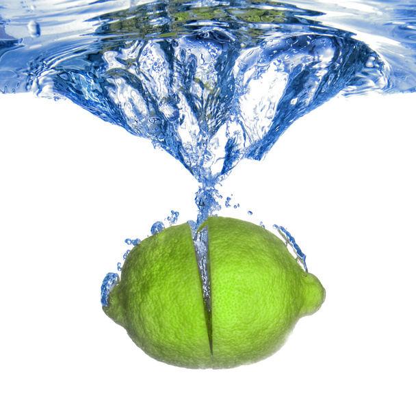 Fresh lime dropped into water - Photo, Image