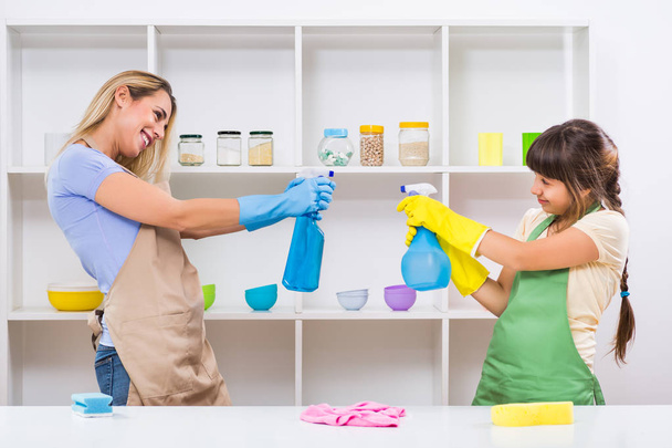 Mother and daughter having fun while cleaning - Φωτογραφία, εικόνα