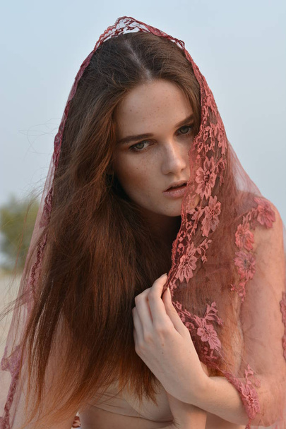Portrait of an elegant young woman with a shawl on her face - Foto, Bild