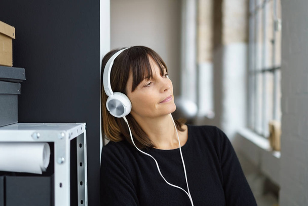 Woman listening to music or a recording - Photo, Image
