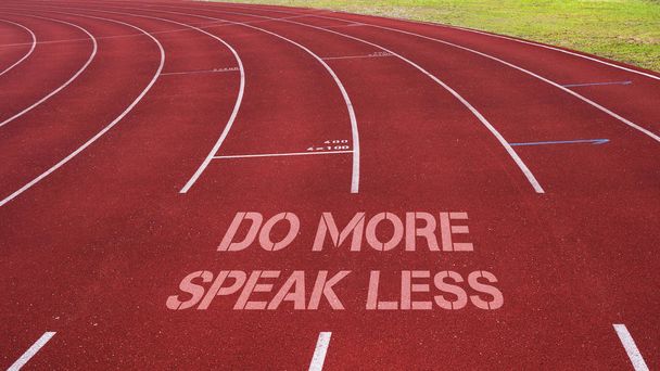 Motivational quote written on running track: Do More Speak Less - Photo, Image