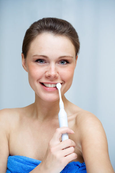 Woman cleaning her teeth by toothbrush - Fotografie, Obrázek