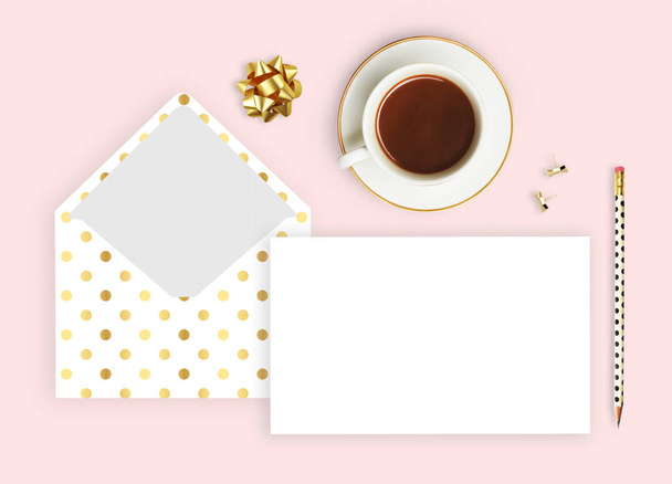 Flat lay. Pink background, envelope pattern polka gold, coffee cup and pencil. Business desktop. Invitation mockup. - Photo, Image