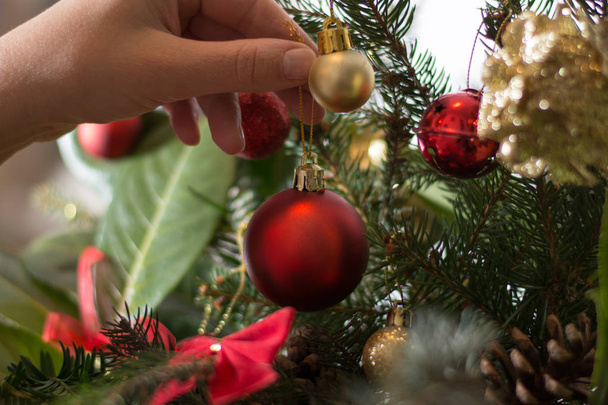 Decorating Christmass bouqet  with red ornaments and tree branch - Photo, Image