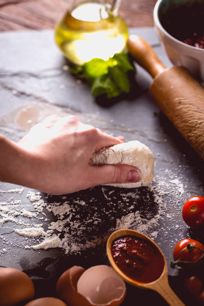 Young girl's hand knead the dough - Foto, Imagen