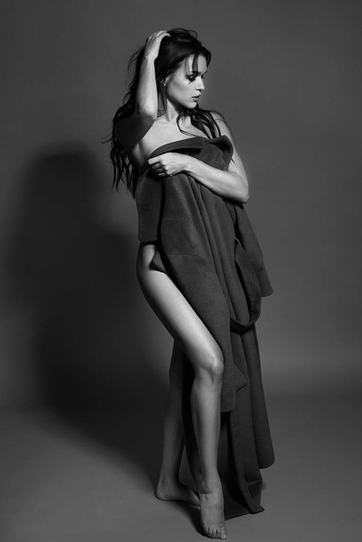 Black and white photo of a seductive brunette girl in studio. Sexy topless woman. Monochrome image. - 写真・画像