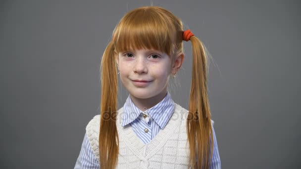 Cute ginger girl with two pigtails looking onto the camera - Footage, Video