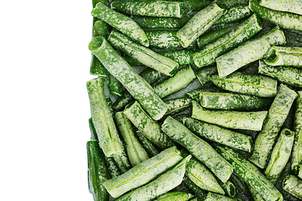 Border of fresh frozen green french bean with hoarfrost closeup on white background. - Foto, afbeelding